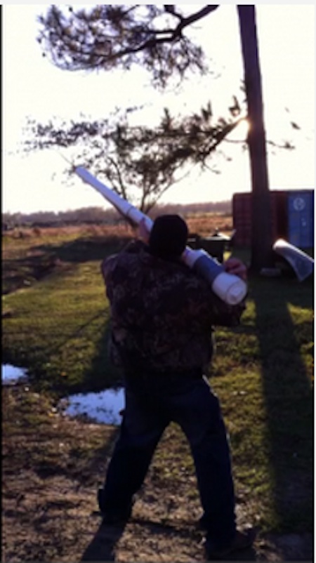 A person holds a long white tube.