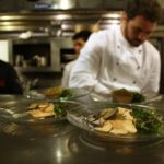 Madidi Executive Chef Levi Minyard's course ready to be consumed. Chefs busy in background. Photo by Rachel Bush.