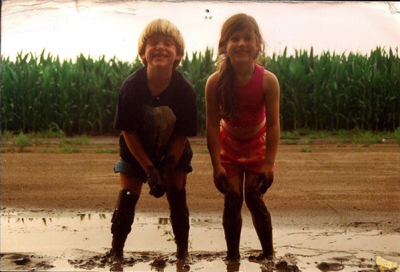 Young & Free columnist Corinne Vance beside a Mississippi Delta corn field with her first cousin