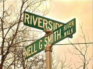 Street signs for Riverside, Nell G. Smith, and River Walk.