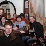 Group of friends gathered around a table in a pub.