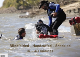 Jay Platt, former Marine, finishing his swim across the Mississippi River blindfolded, handcuffed and shackled.