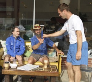 John Ruskey founder of Quapaw Canoe Company holds World Harmony Run torch as two volunteer runners look on. The 25th Anniversary USA 10,000 mile tour made a return visit to Clarksdale. Photo by DELTA BOHEMIAN