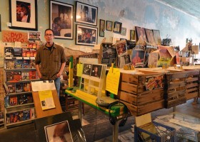 Man in a record store looking at vinyl records.