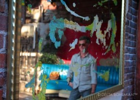 A Mirror offered by Delta Debris with artist Randall Andrews in reflection.