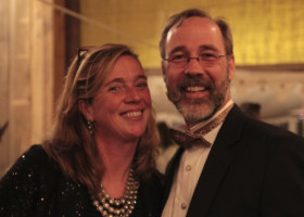 Couple smiling at a formal event.