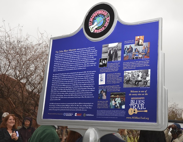 The back of the Delta Blues Museum marker features a colorful logo of the Muddywood guitar, a gift to the Delta Blues Museum by rock stars ZZ Top in 1988, and historical photographs of the museum. Photo by Panny Mayfield