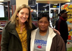 Two women smiling in a fast food restaurant.