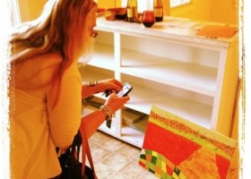 Woman taking a photo of an abstract painting.