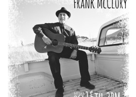 Frank McCloria playing guitar in a truck bed.