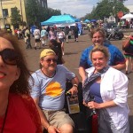 Group of people in front of a food stand.