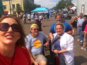 Group of people in front of a food stand.