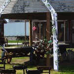 Rustic silo wedding ceremony setup with flowers.