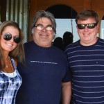 Three friends smiling, two men and a woman.