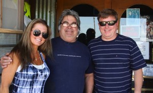 Three friends smiling, two men and a woman.