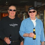 Two men drinking beer in a bar.