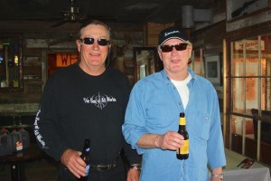 Two men drinking beer in a bar.