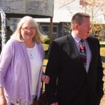 A woman and man standing outside a building.