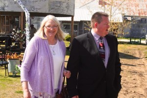 A woman and man standing outside a building.