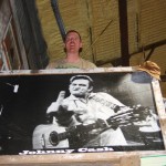 Black and white photo of Johnny Cash playing guitar.