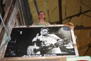 Black and white photo of Johnny Cash playing guitar.