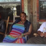 Three friends sitting on rocking chairs.