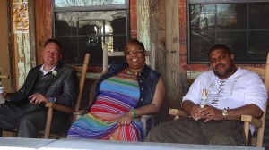 Three friends sitting on rocking chairs.