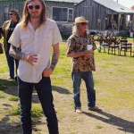 Two men standing outdoors, one wearing sunglasses.