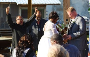 Wedding ceremony with guests and officiant.