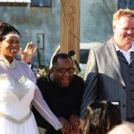 Bride and groom smiling at wedding ceremony.