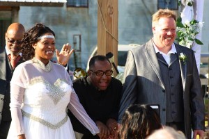 Bride and groom smiling at wedding ceremony.