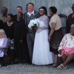 Wedding group portrait with bride and groom.