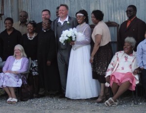 Wedding group portrait with bride and groom.