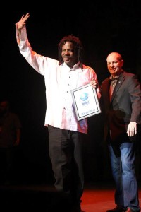 Two men holding an award for Blues music.