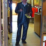 Man in suit standing in doorway.