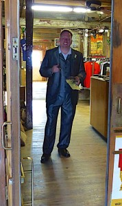 Man in suit standing in doorway.