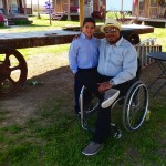 Man in wheelchair with a young boy.