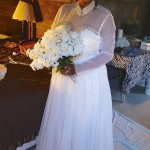 Bride in white dress holding bouquet.