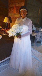 Bride in white dress holding bouquet.