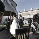 Wedding ceremony with bride and groom outdoors.