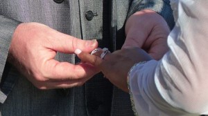 A man and woman exchanging rings.