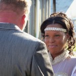 Groom in suit with bride in white dress.