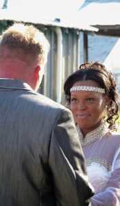 Groom in suit with bride in white dress.