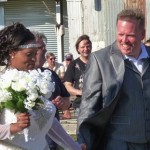 Bride and groom smiling at wedding ceremony.