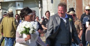 Bride and groom smiling at wedding ceremony.