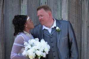 Bride and groom smiling with a bouquet.