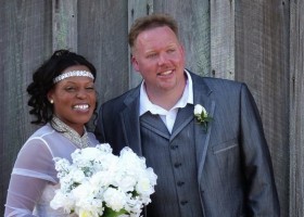 Bride and groom smiling on their wedding day.