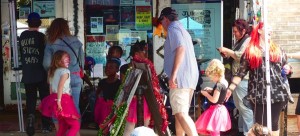 Group of people shopping at a market stall.