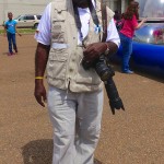 Man with camera in a parking lot.