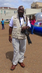 Man with camera in a parking lot.